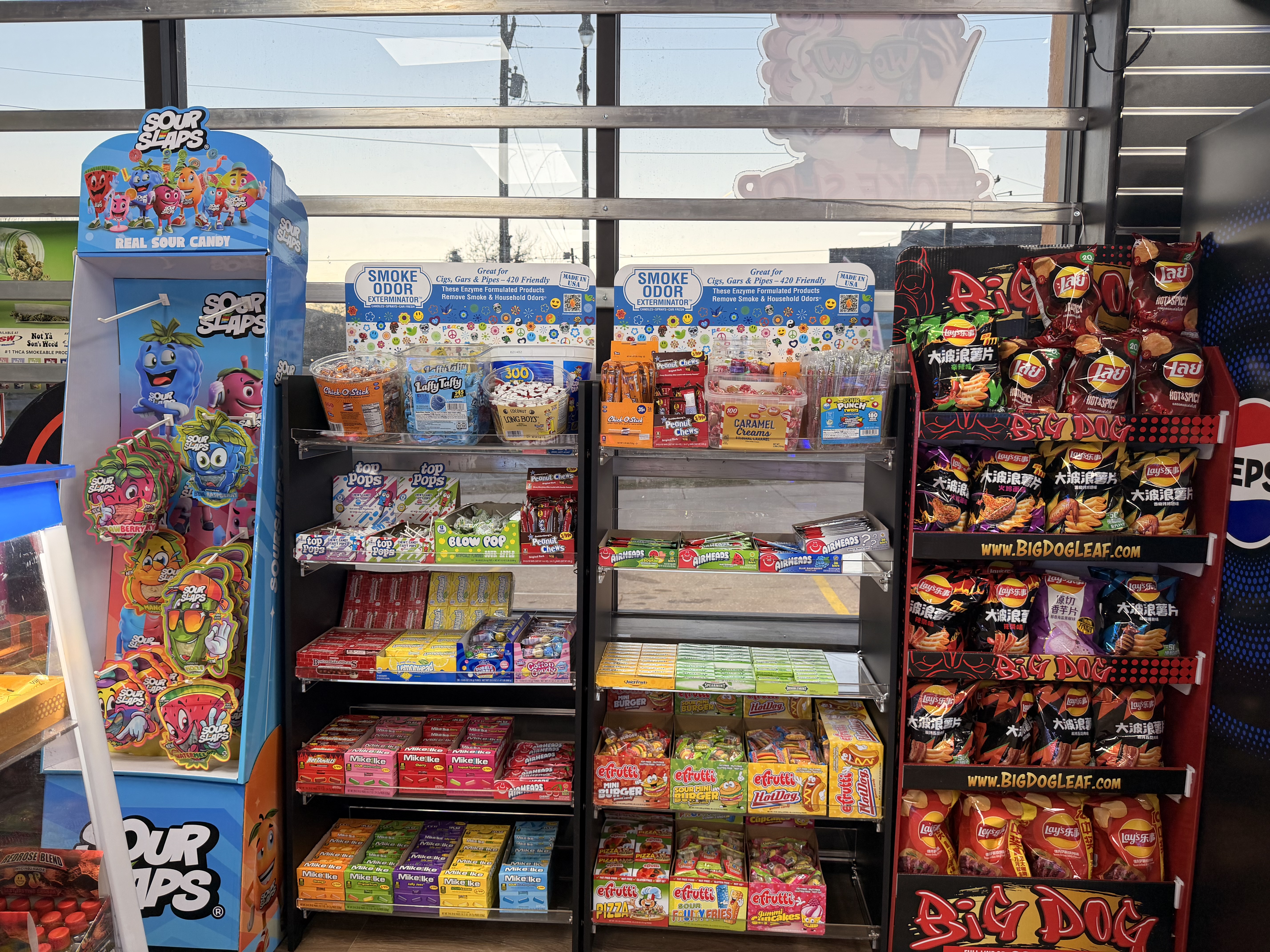 Exotic snacks display with Sour Slaps candy, imported chips, and unique treats