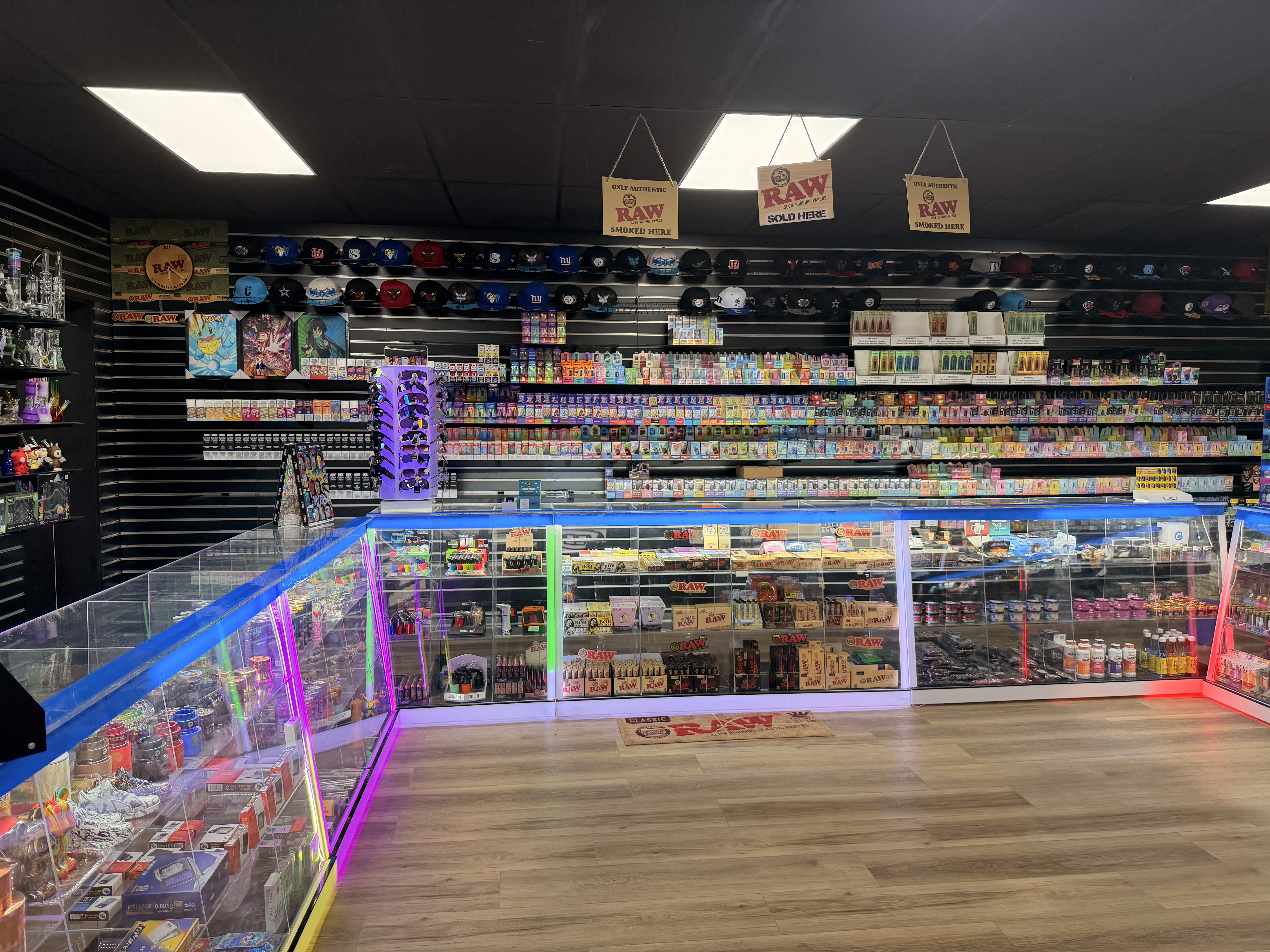Store interior showing product shelves with RAW accessories and LED-lit cases